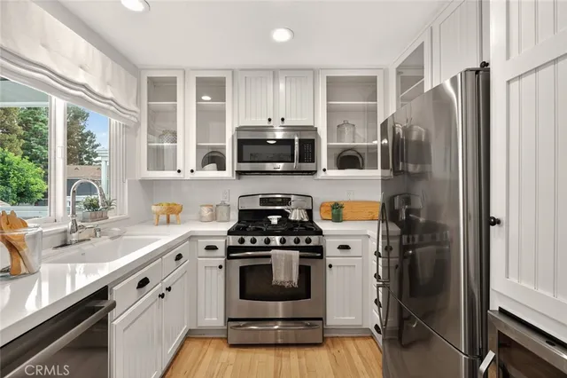 a kitchen with a stove a microwave and refrigerator