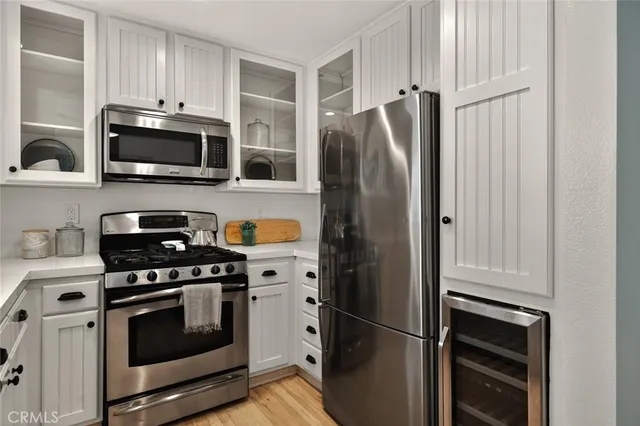 a kitchen with stainless steel appliances a refrigerator stove and microwave