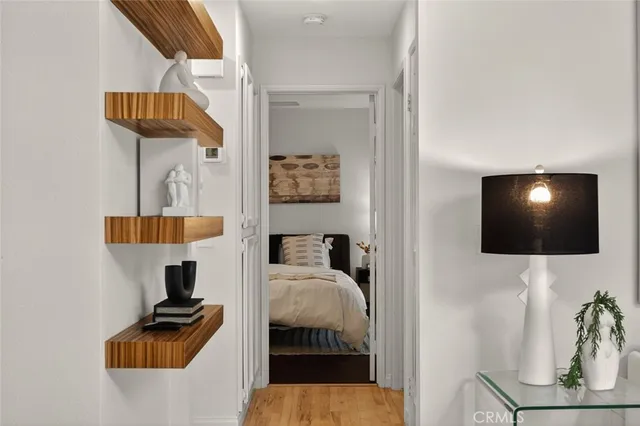 a hallway with a couch and a flat screen tv