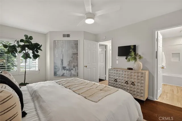 a bedroom with a bed and a television