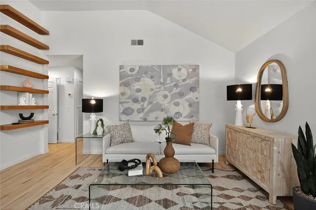a living room with furniture a rug and a floor to ceiling window