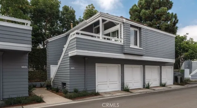 a view of a house with a garage and balcony