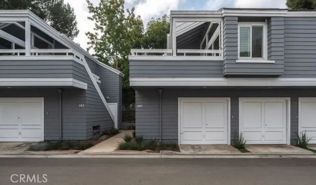 a view of a house with a garage and balcony