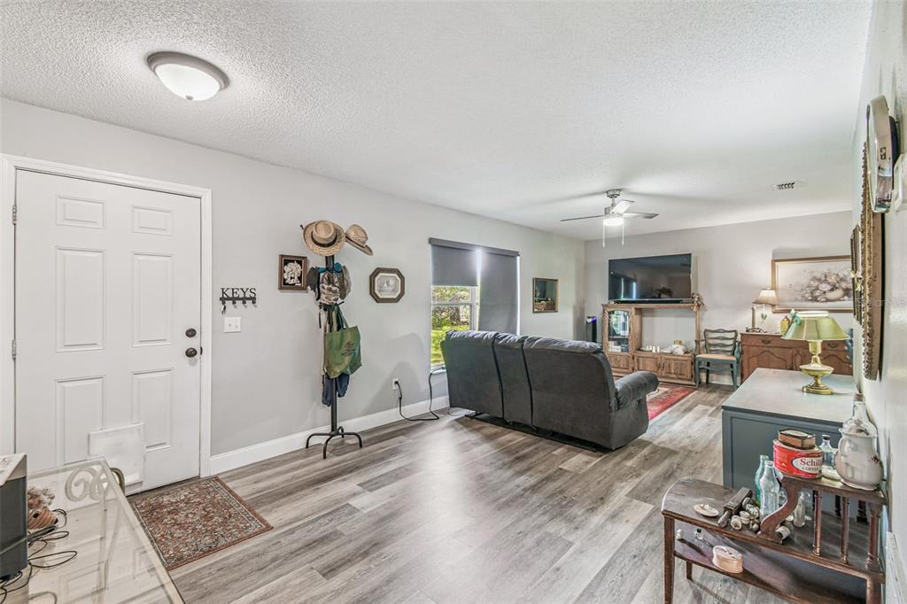 1317 Carl Street Inverness, FL 34453 - Photo 4 of 20 a living room with furniture and a flat screen tv