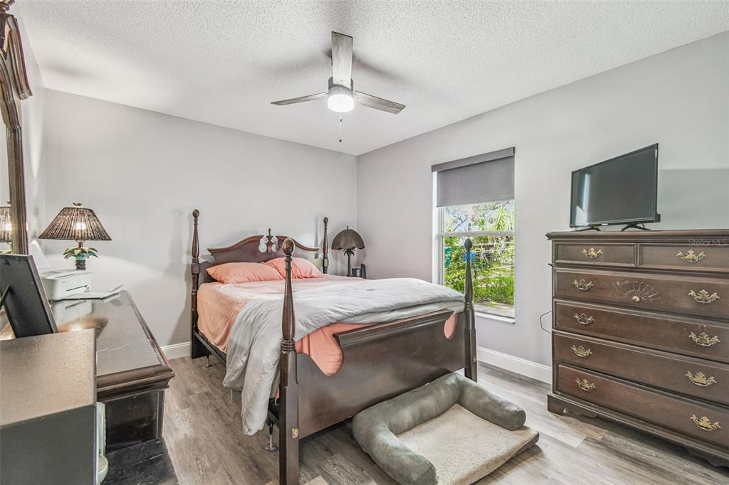 1317 Carl Street Inverness, FL 34453 - Photo 9 of 20 a bedroom with a bed and a flat screen tv