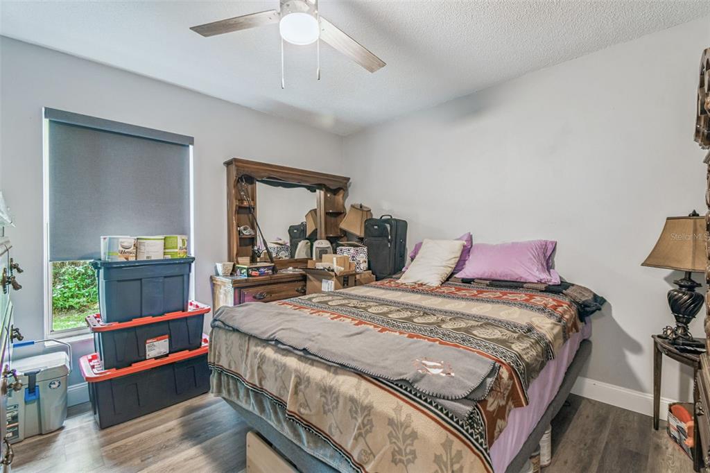 1317 Carl Street Inverness, FL 34453 - Photo 10 of 20 a bed room with a bed and a chandelier