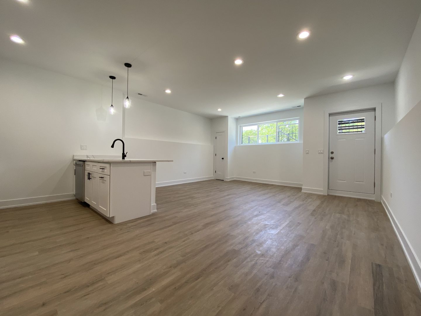 4047 South Prairie Avenue, Unit 2 Chicago, IL 60653 - Photo 4 of 6 an empty room with wooden floor and windows