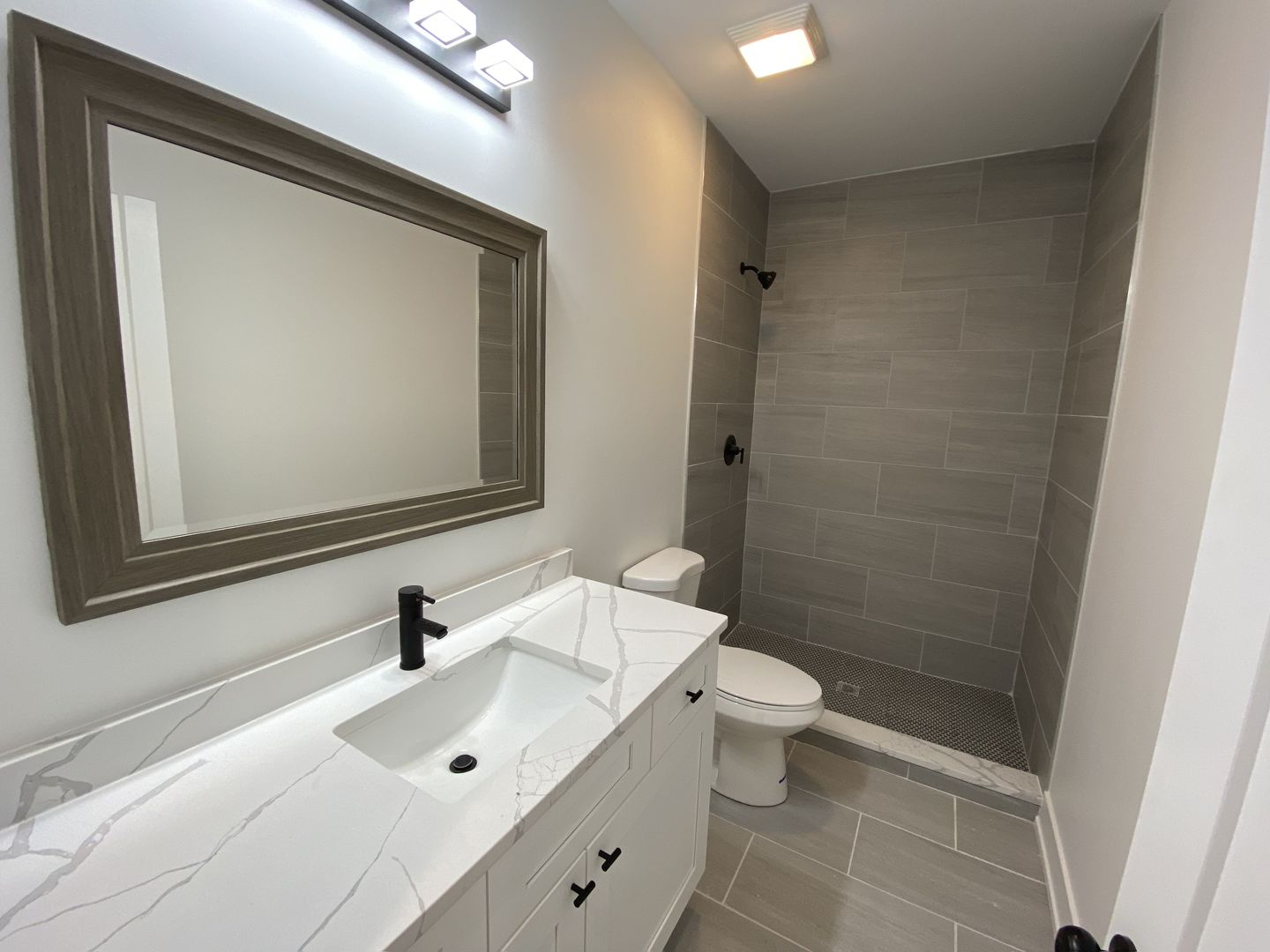 4047 South Prairie Avenue, Unit 2 Chicago, IL 60653 - Photo 5 of 6 a bathroom with a toilet a sink and mirror