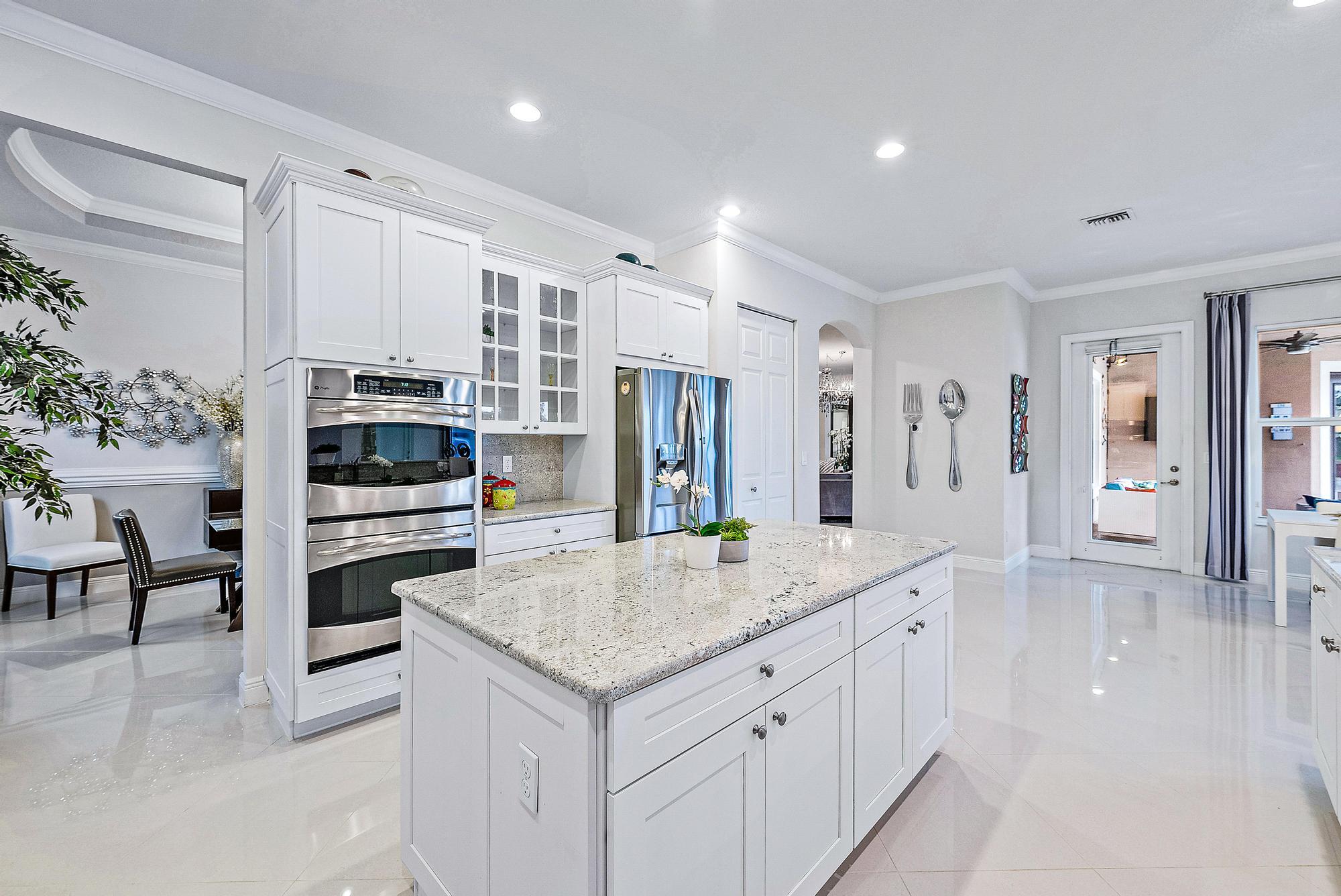 127 Steeple Circle Jupiter, FL 33458 - Photo 11 of 56 a kitchen with stainless steel appliances a stove sink and cabinets