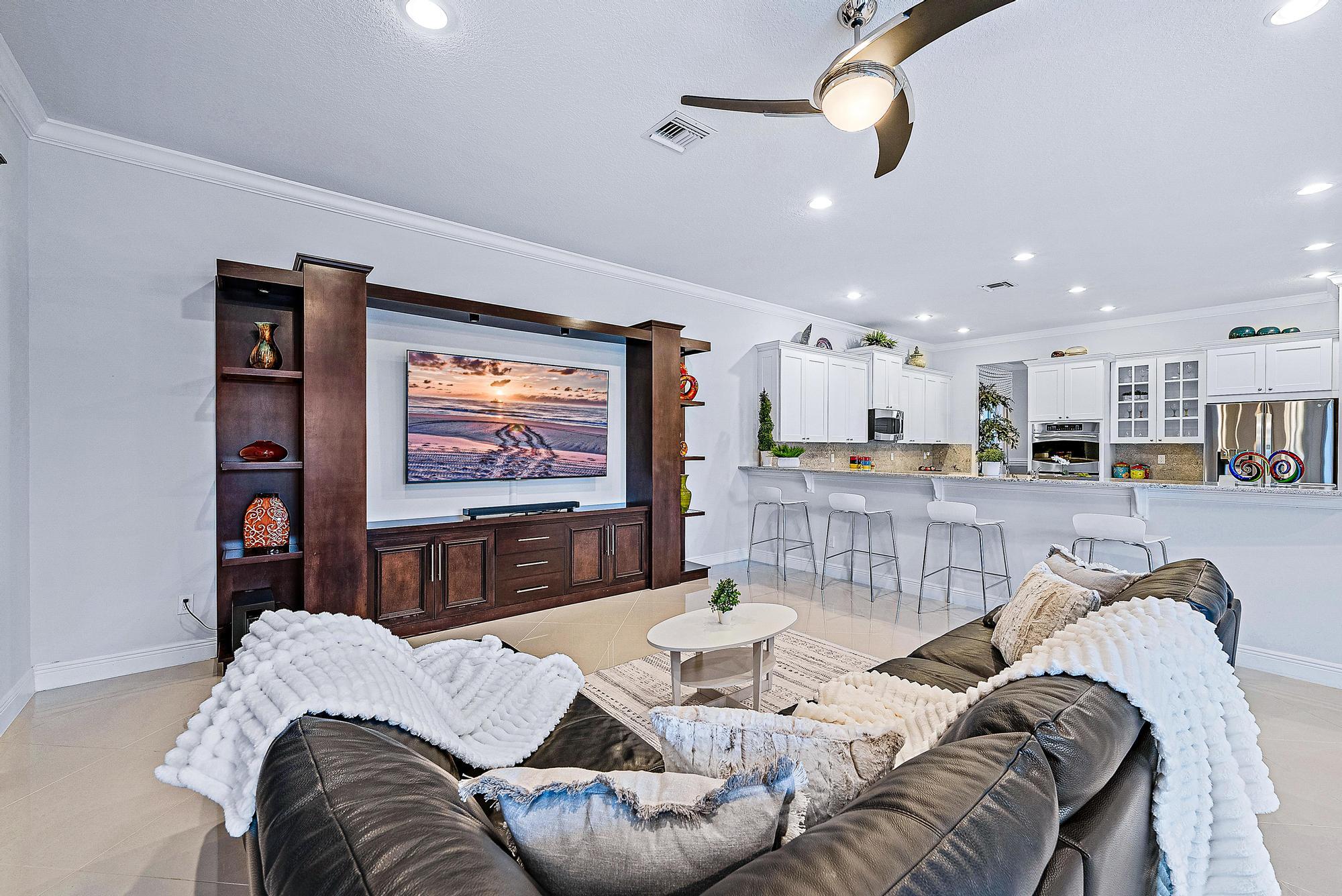 127 Steeple Circle Jupiter, FL 33458 - Photo 15 of 56 a living room with furniture and a flat screen tv