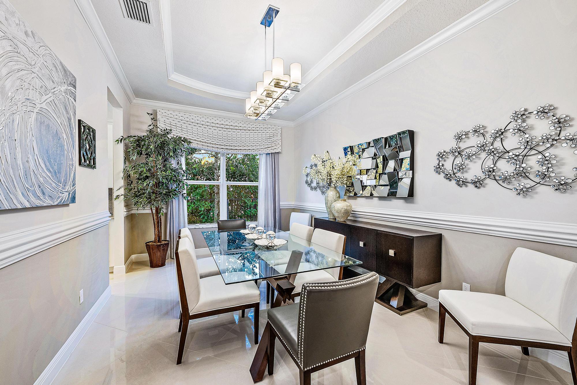 127 Steeple Circle Jupiter, FL 33458 - Photo 17 of 56 a dining room with furniture a rug and a chandelier