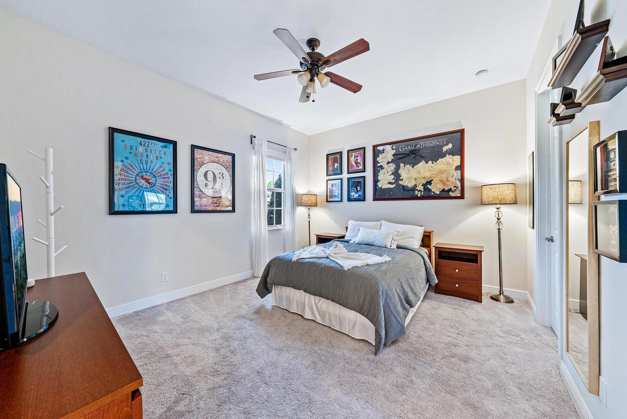 127 Steeple Circle Jupiter, FL 33458 - Photo 29 of 56 a spacious bedroom that has a bed and a chandelier