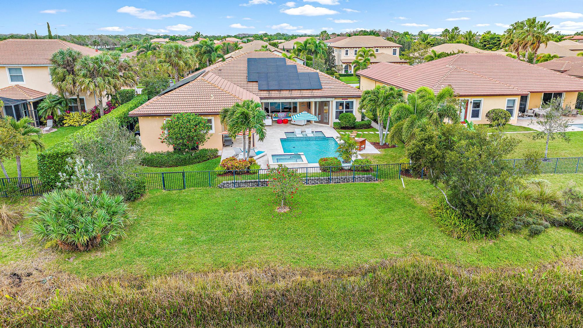127 Steeple Circle Jupiter, FL 33458 - Photo 40 of 56 an aerial view of residential houses with outdoor space and trees all around