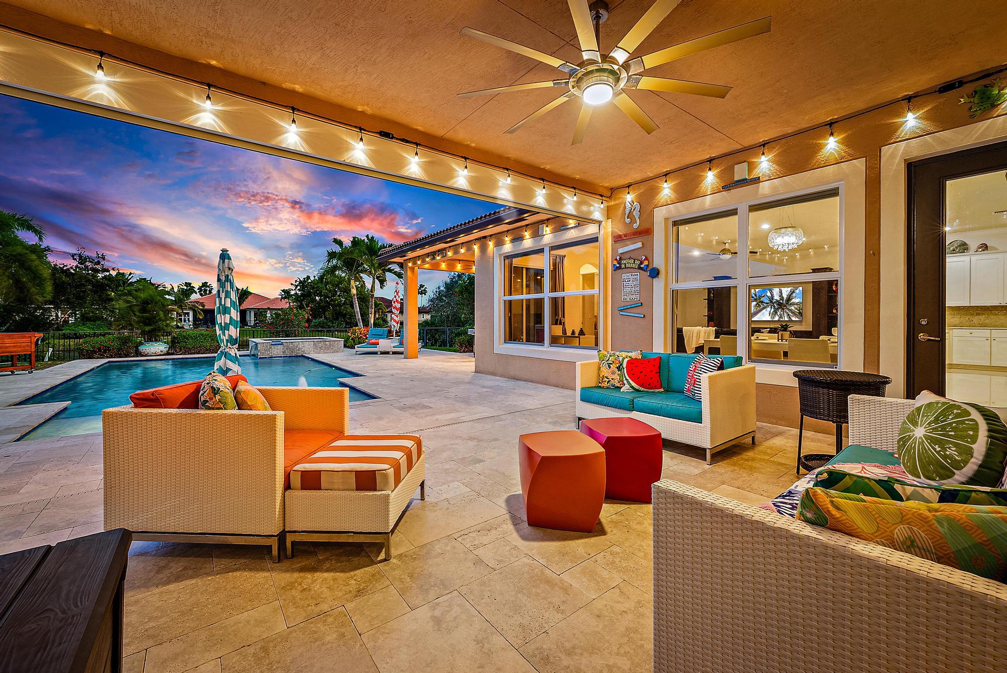 127 Steeple Circle Jupiter, FL 33458 - Photo 4 of 56 a outdoor space with patio couches and a fireplace