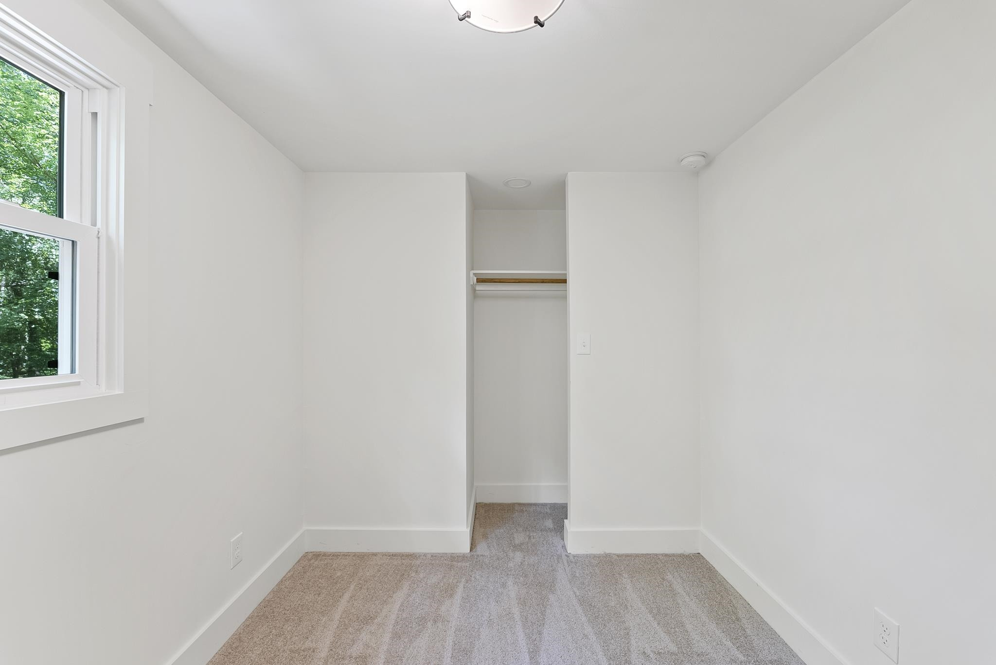 7604 Filgate Court Raleigh, NC 27615 - Photo 25 of 34 a view of an empty room with wooden floor and a window