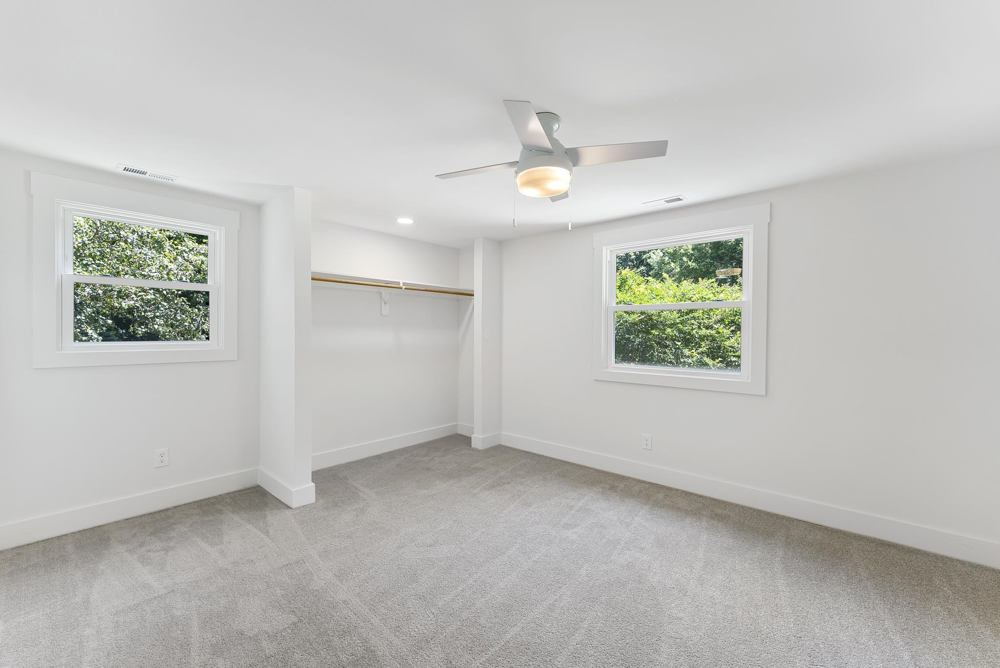 7604 Filgate Court Raleigh, NC 27615 - Photo 29 of 34 an empty room with windows and ceiling fan view