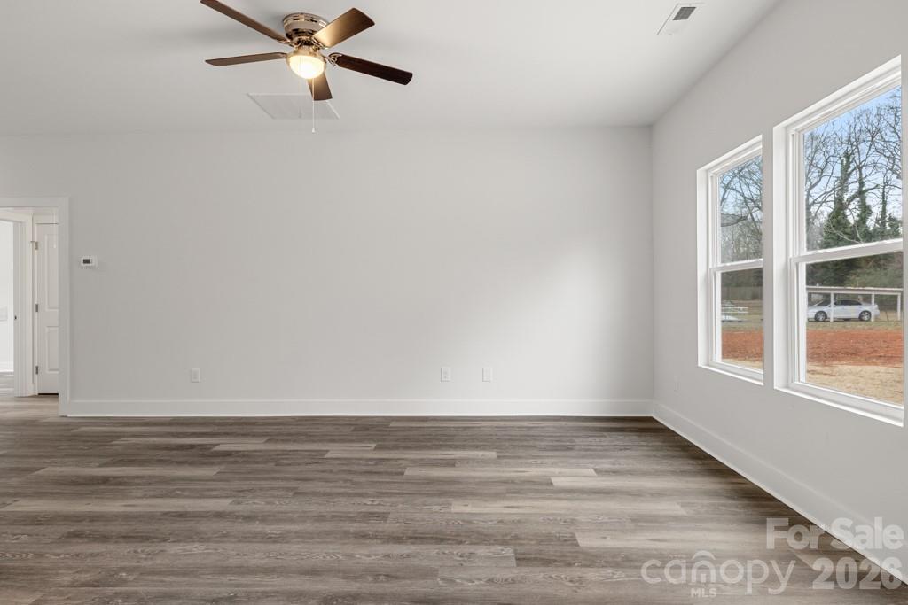 1212 Patterson Street Shelby, NC 28152 - Photo 12 of 24 a view of an empty room with a window and wooden floor