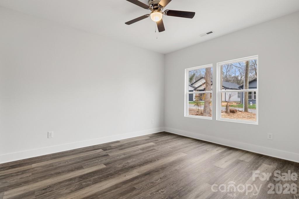 1212 Patterson Street Shelby, NC 28152 - Photo 14 of 24 a view of an empty room with wooden floor and a window