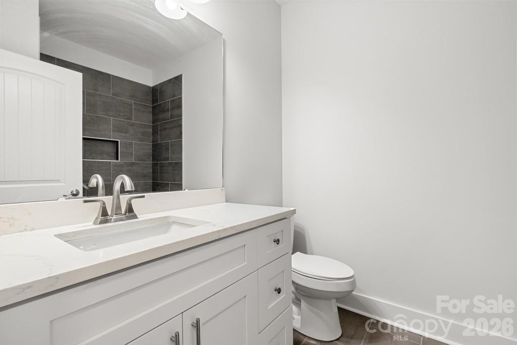 1212 Patterson Street Shelby, NC 28152 - Photo 19 of 24 a bathroom with a sink a toilet and mirror