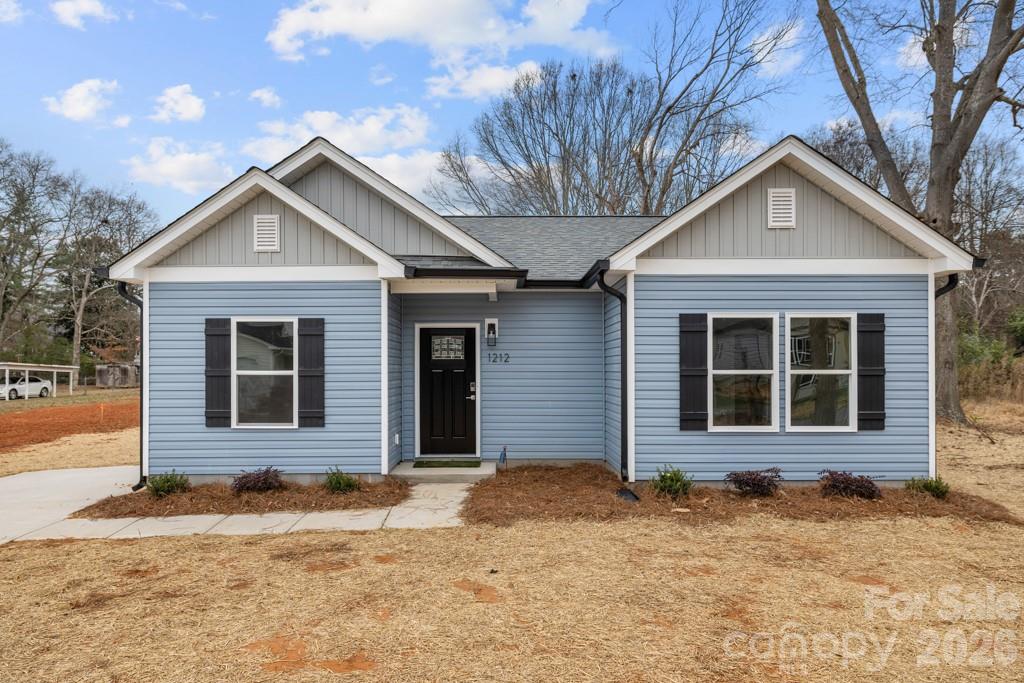 1212 Patterson Street Shelby, NC 28152 - Photo 2 of 24 a front view of a house with a yard and garage