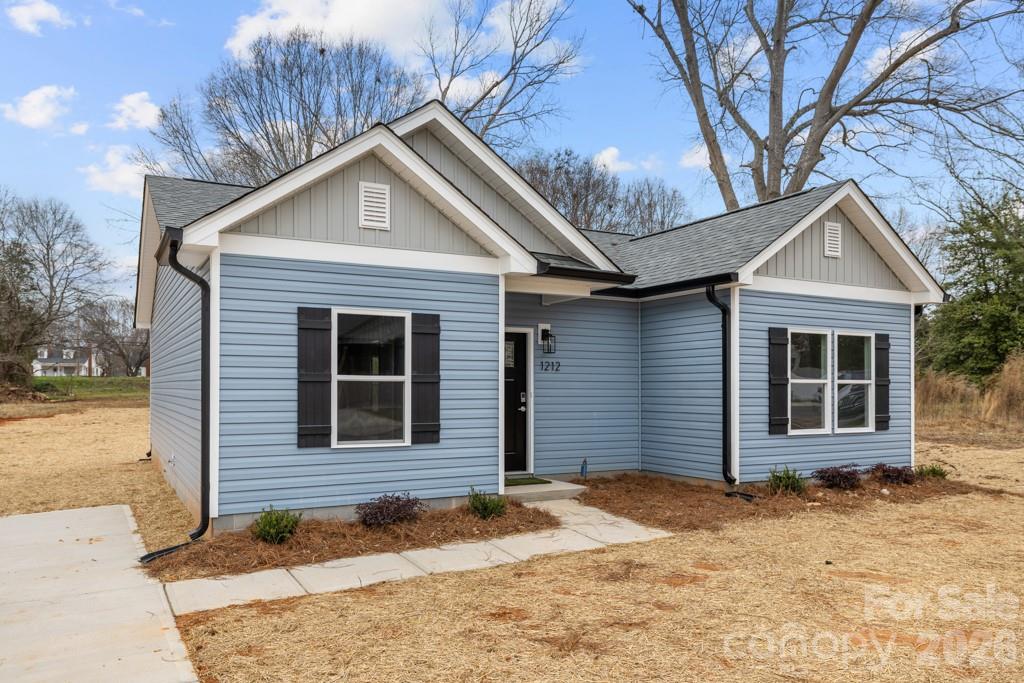 1212 Patterson Street Shelby, NC 28152 - Photo 4 of 24 a front view of a house with a yard and garage
