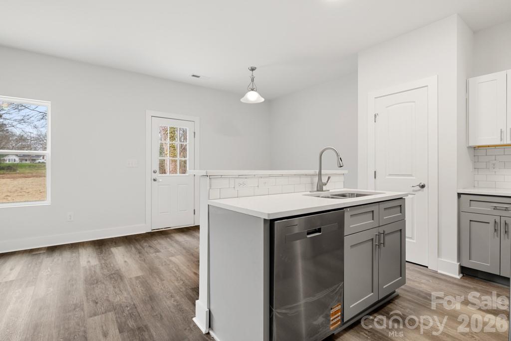 1212 Patterson Street Shelby, NC 28152 - Photo 6 of 24 a kitchen with a sink cabinets and wooden floor