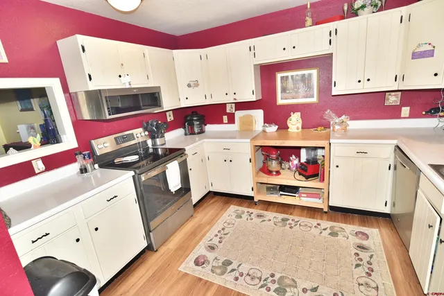 a utility room with cabinets and white appliances