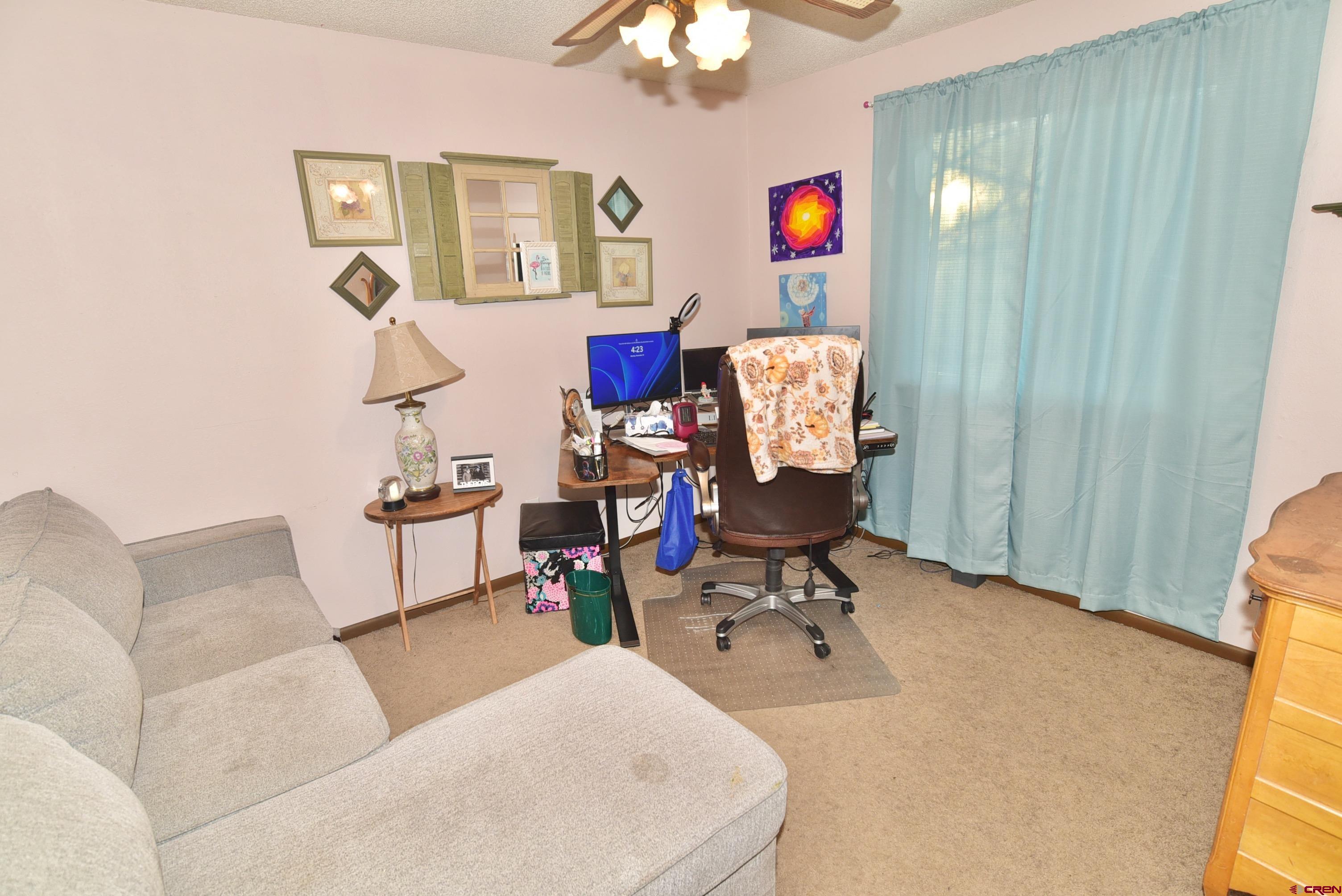 114 Cedar Street Delta, CO 81416 - Photo 15 of 31 a living room with furniture and a chandelier