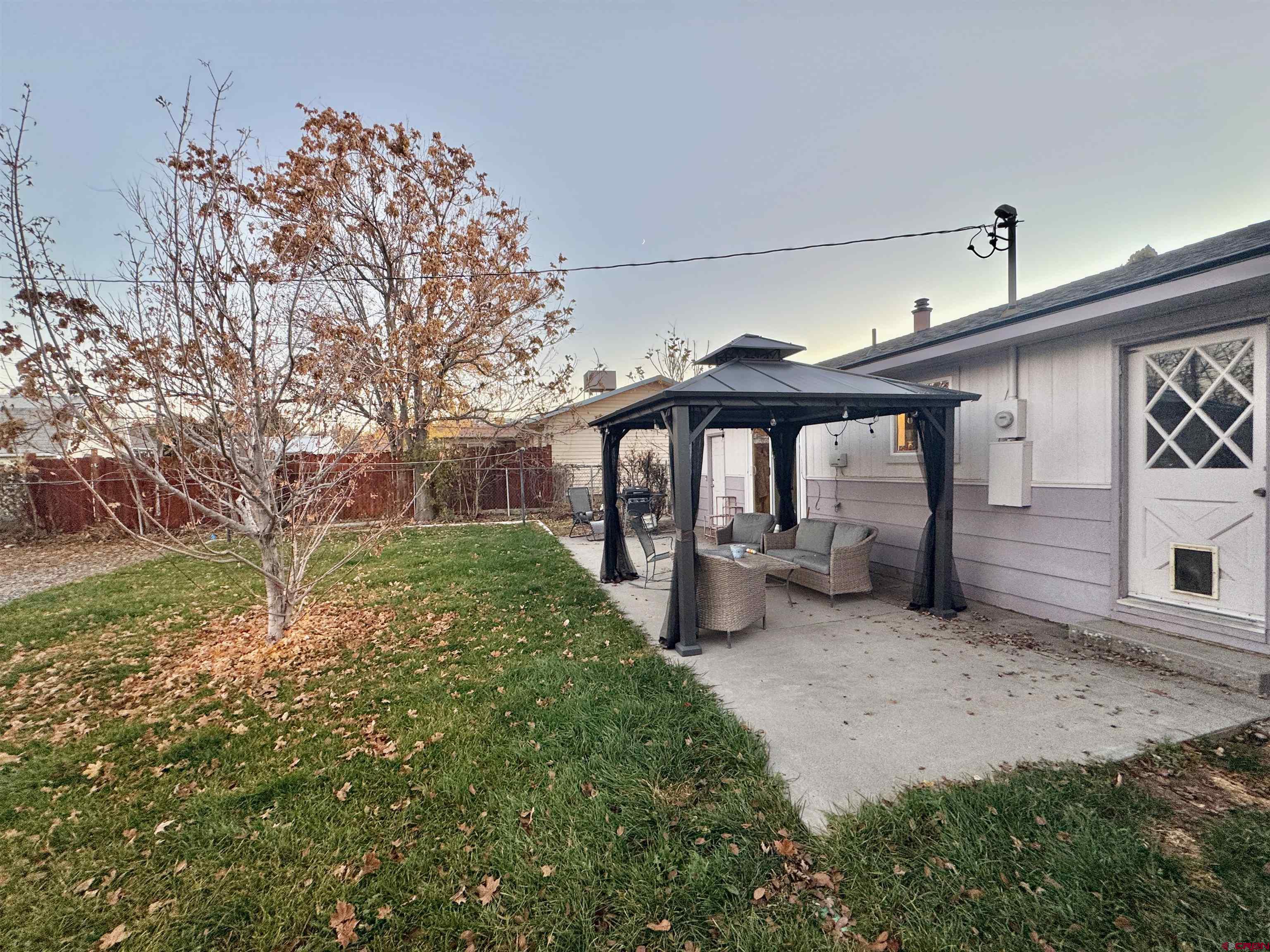 114 Cedar Street Delta, CO 81416 - Photo 21 of 31 a view of a chair and table in backyard of house