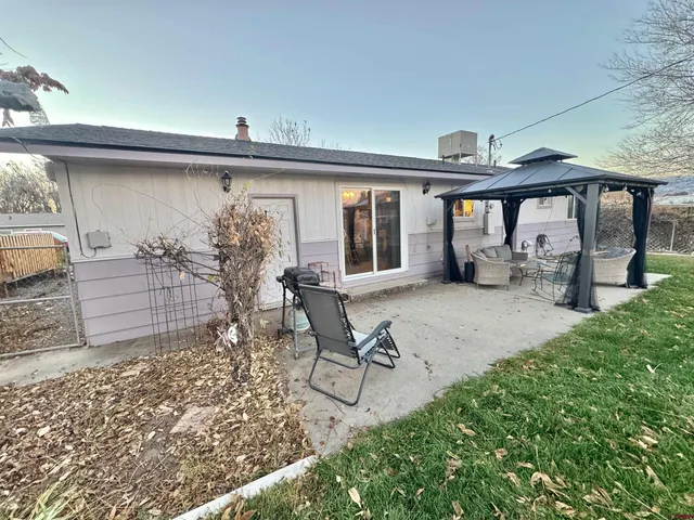 a view of a patio with furniture and a yard