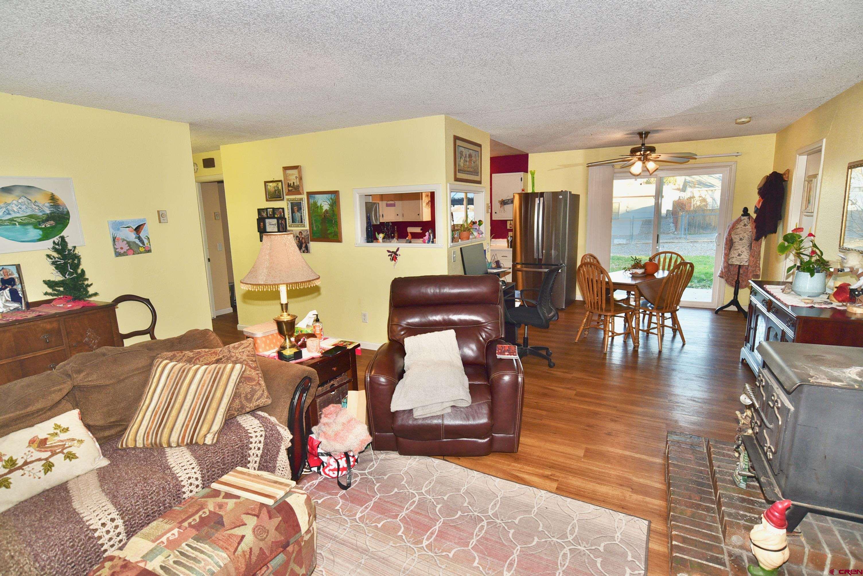 114 Cedar Street Delta, CO 81416 - Photo 3 of 31 a living room with furniture and wooden floor