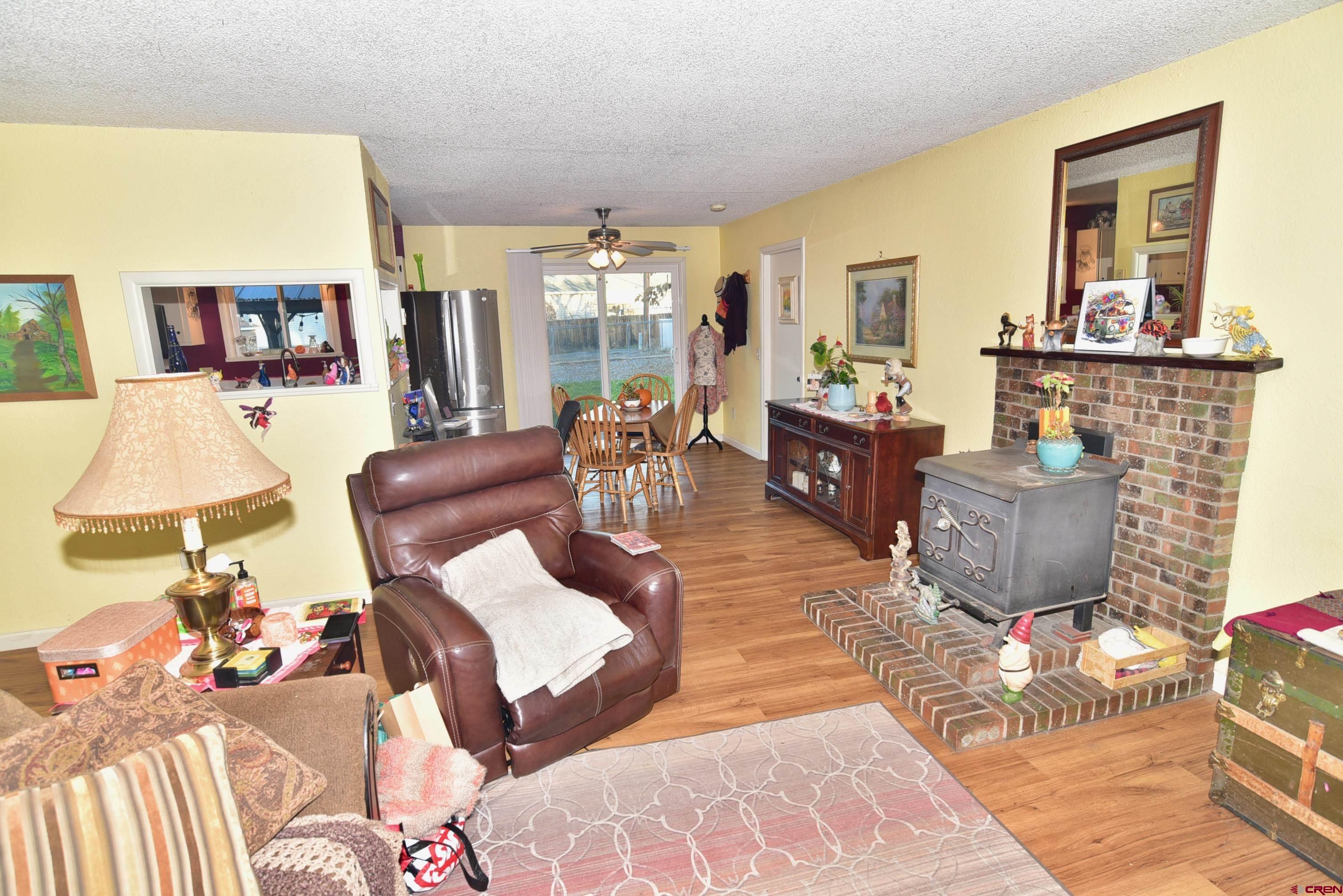114 Cedar Street Delta, CO 81416 - Photo 6 of 31 a living room with furniture a flat screen tv and a table