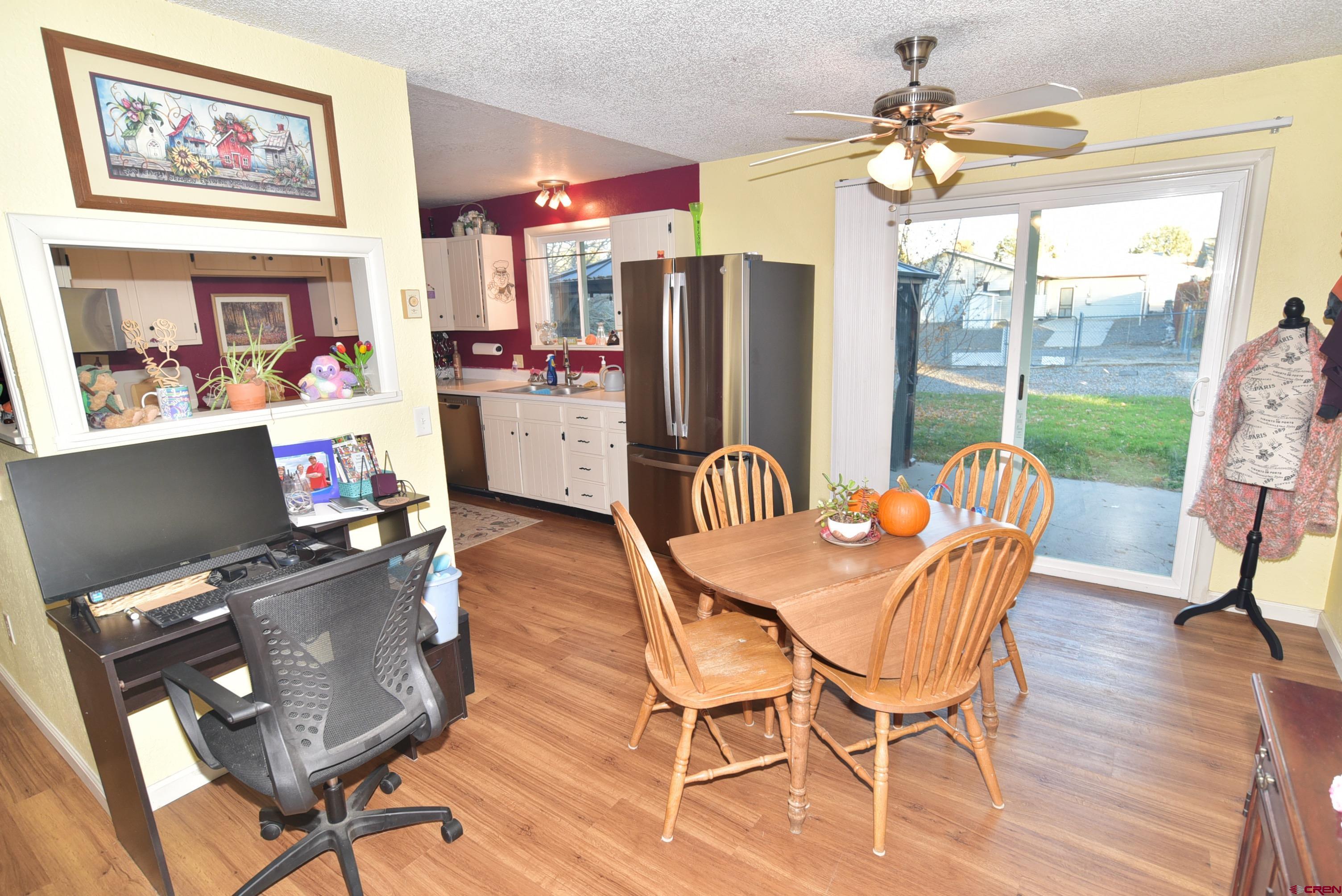114 Cedar Street Delta, CO 81416 - Photo 8 of 31 a dining room with furniture a chandelier and wooden floor