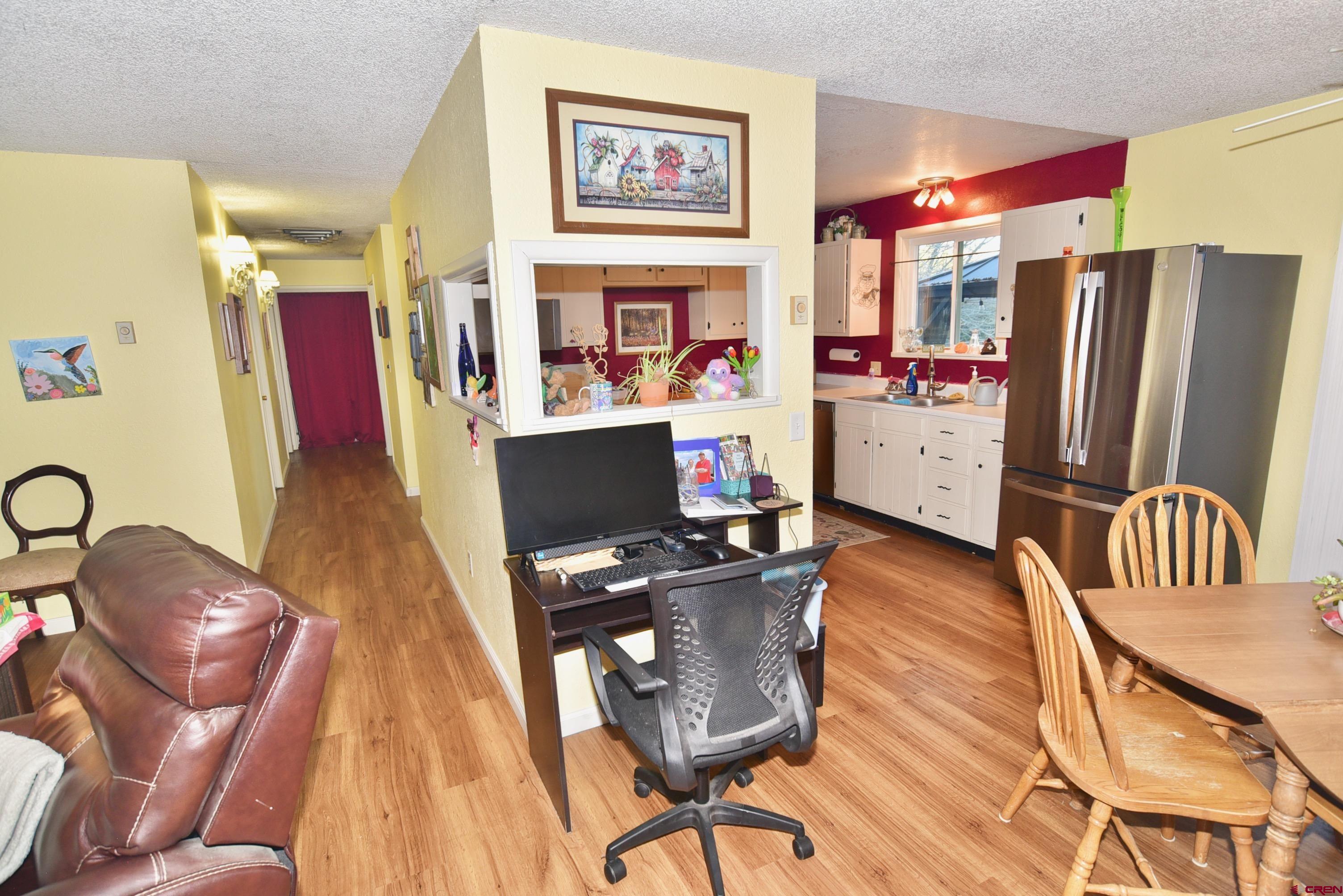 114 Cedar Street Delta, CO 81416 - Photo 9 of 31 a view of a workspace with furniture and a livingroom