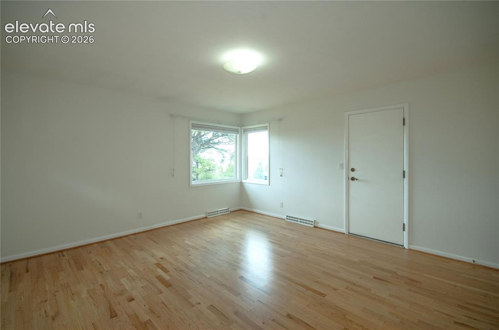 4710 Limestone Road Monument, CO 80132 - Photo 27 of 50 an empty room with wooden floor and windows