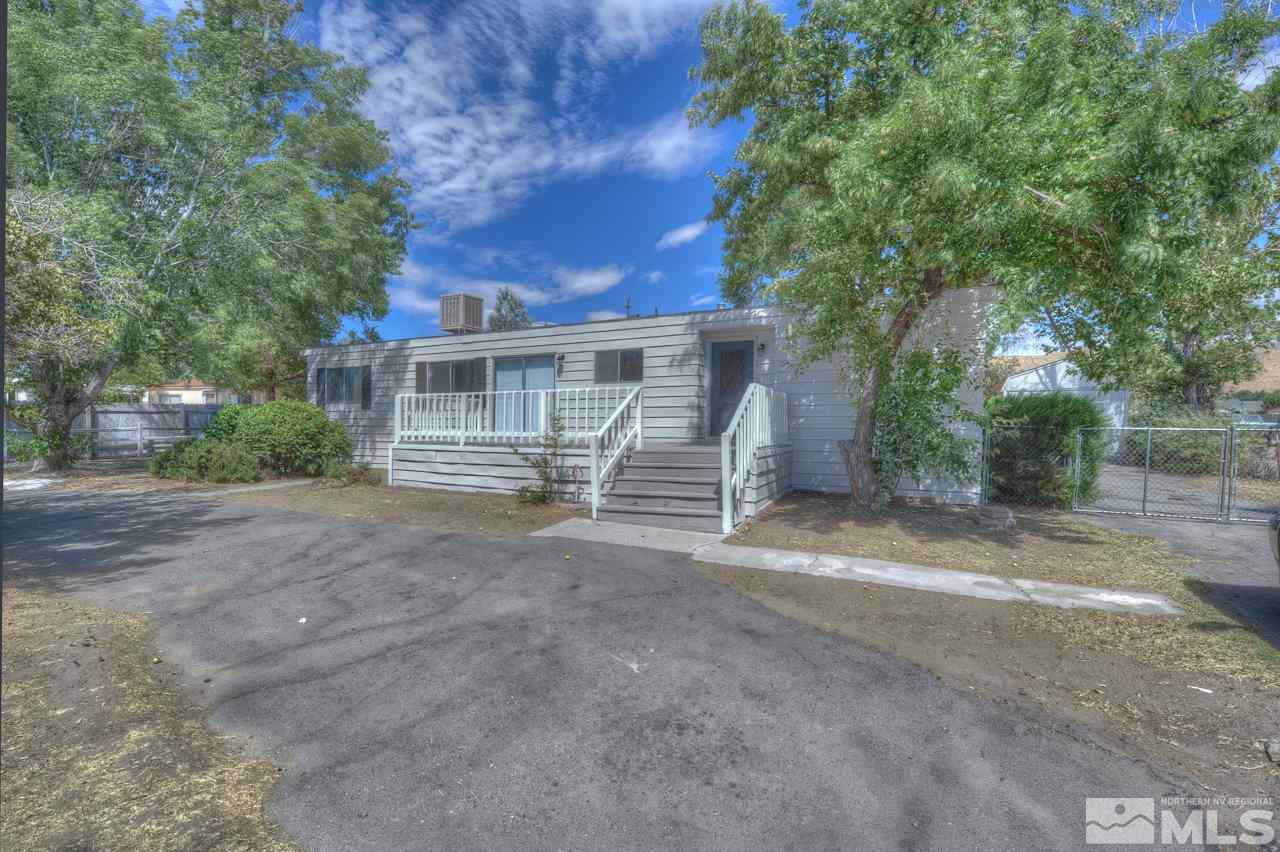 3560 Hummingbird Drive Reno, NV 89508 - Photo 1 of 1 a view of a house with a yard and large tree