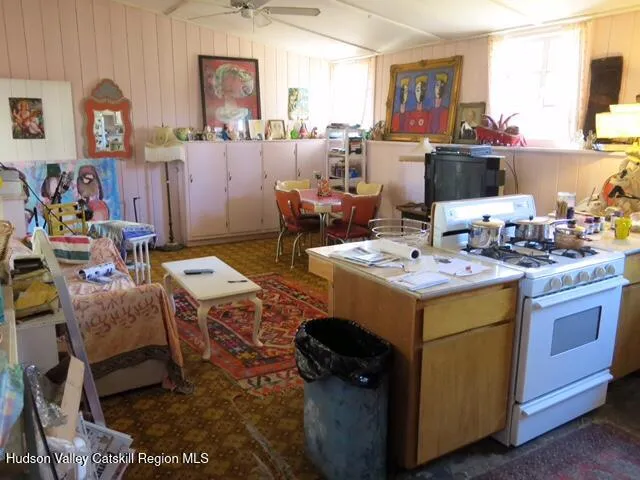 a living room with lots of furniture and kitchen view