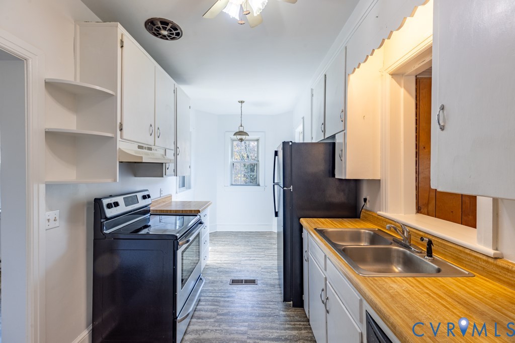 106 Courthouse Road Blackstone, VA 23824 - Photo 11 of 27 a kitchen with stainless steel appliances granite countertop a sink stove and refrigerator
