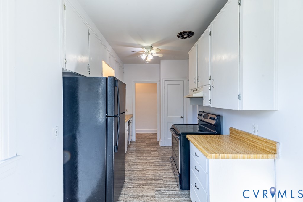 106 Courthouse Road Blackstone, VA 23824 - Photo 12 of 27 a kitchen with a refrigerator a sink and cabinets