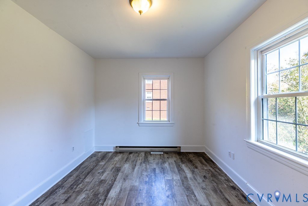 106 Courthouse Road Blackstone, VA 23824 - Photo 16 of 27 an empty room with wooden floor and windows