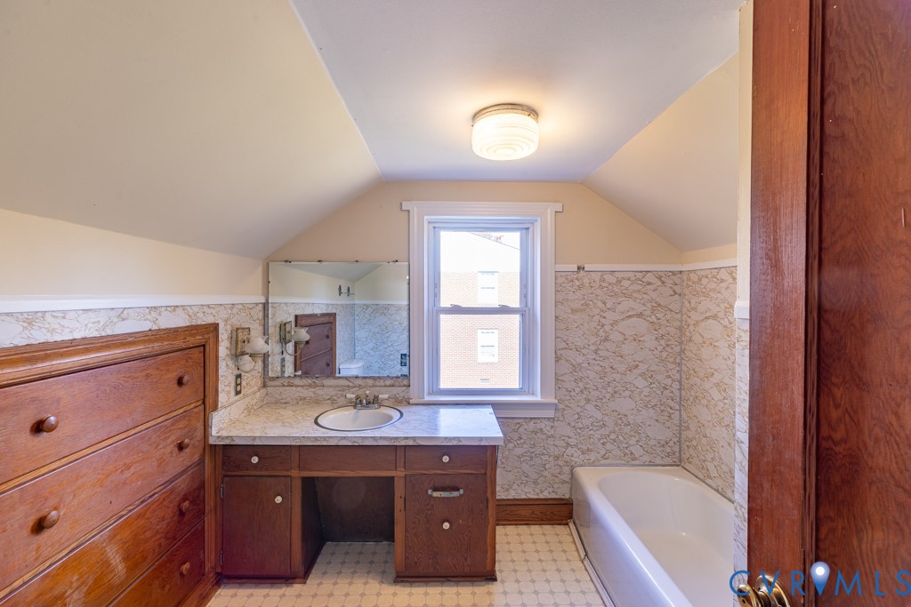 106 Courthouse Road Blackstone, VA 23824 - Photo 22 of 27 a bathroom with a tub sink and mirror