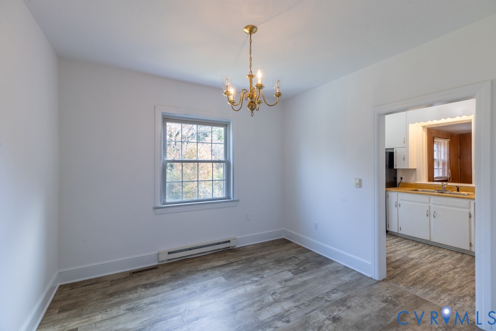 106 Courthouse Road Blackstone, VA 23824 - Photo 7 of 27 a view of an empty room with window and wooden floor