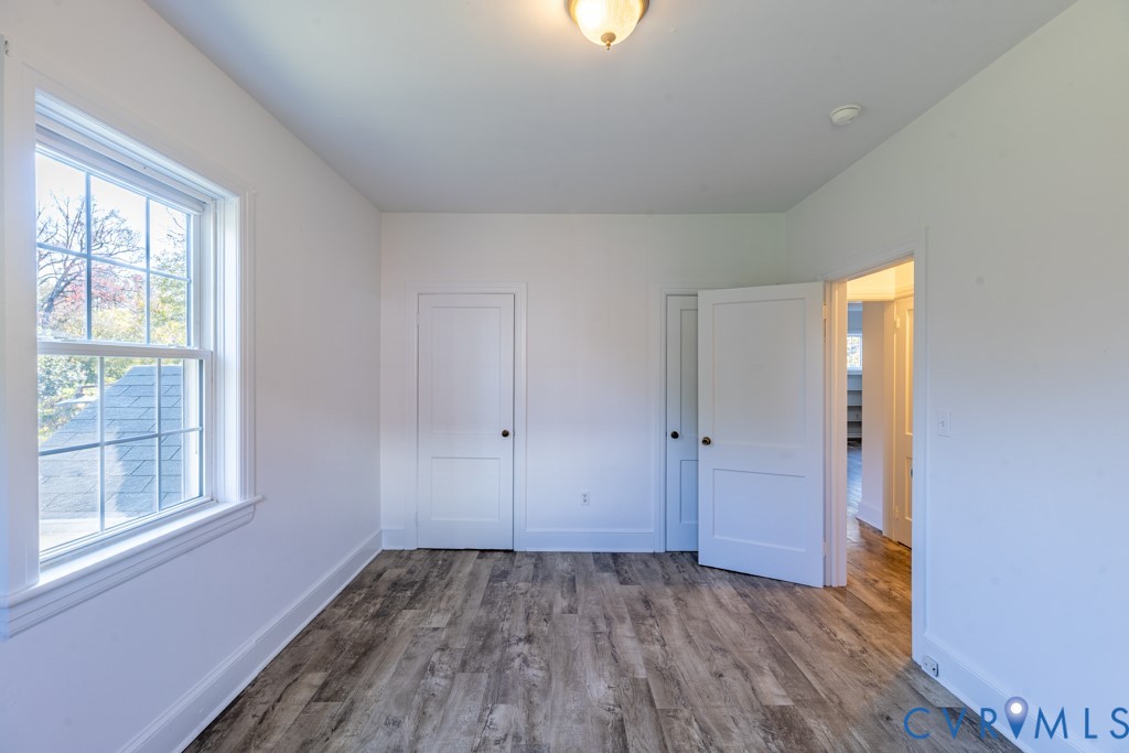 106 Courthouse Road Blackstone, VA 23824 - Photo 9 of 27 a view of an empty room with wooden floor and a window