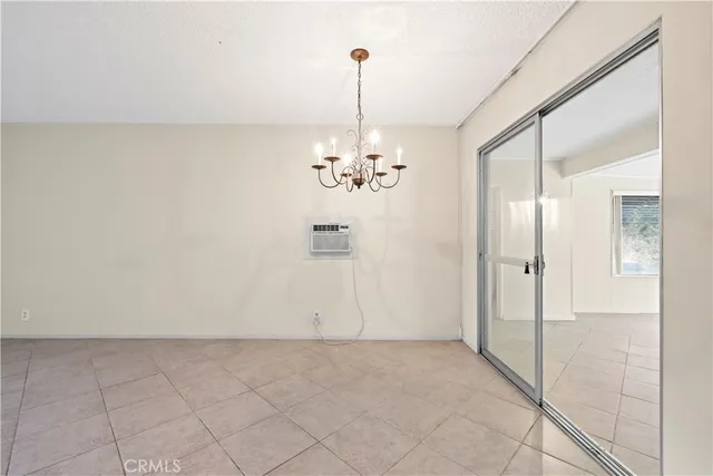 a view of a chandelier in big room and chandelier fan