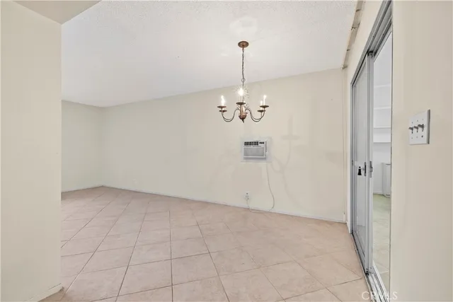 a view of an empty room with chandelier