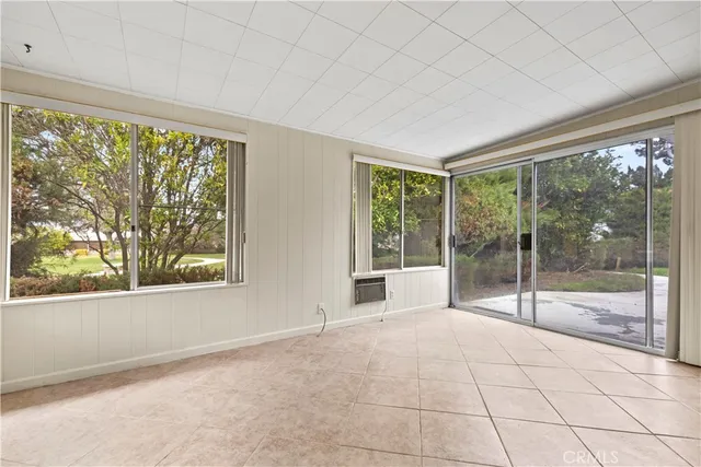 a view of an empty room and window ceiling fan