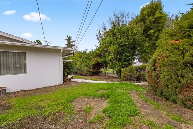 a view of a backyard with plants and a patio