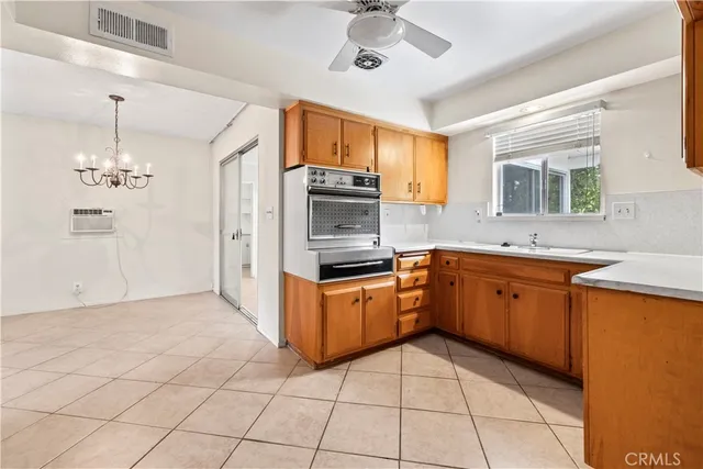 a kitchen with stainless steel appliances granite countertop a sink and dishwasher a refrigerator with a large window