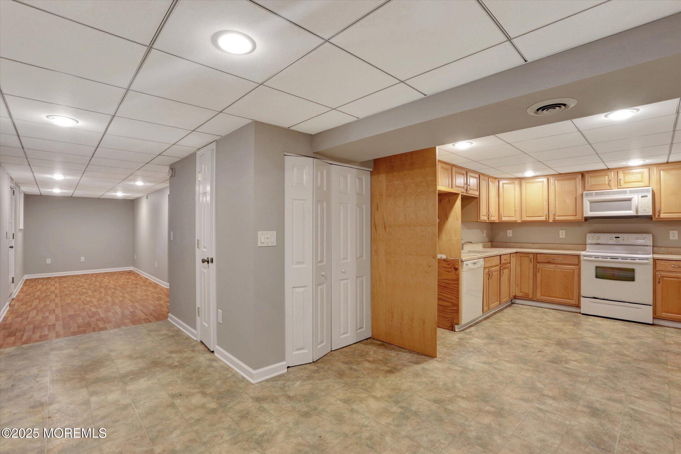 23 Princeton Drive Howell, NJ 07731 - Photo 14 of 32 a view of a kitchen with refrigerator and white cabinets
