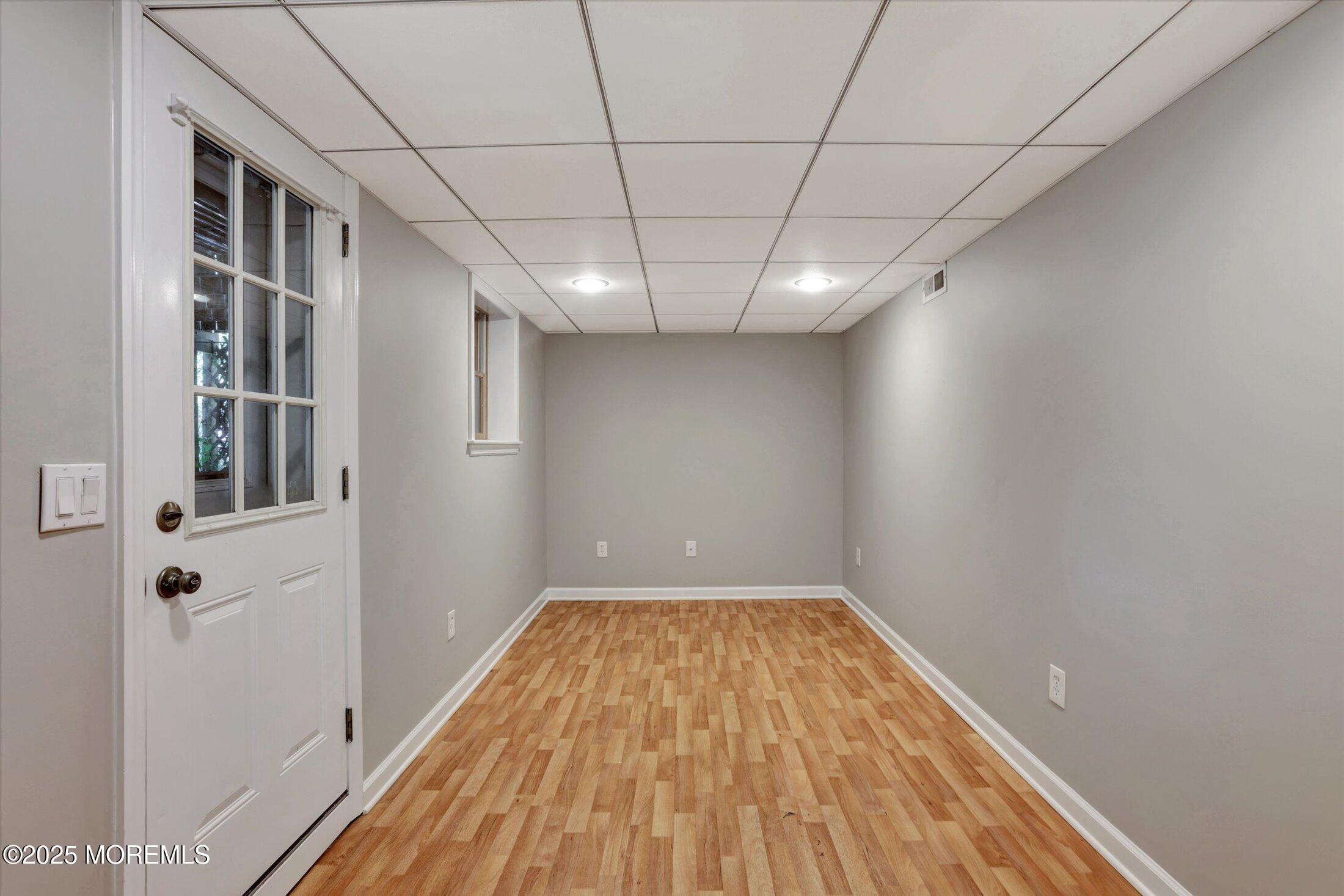 23 Princeton Drive Howell, NJ 07731 - Photo 19 of 32 a view of a big room with wooden floor and windows